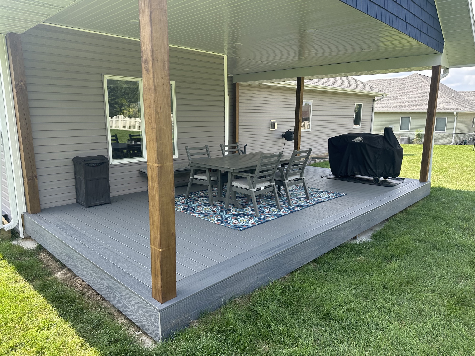Finished covered deck with composite decking, cedar posts and outdoor furniture