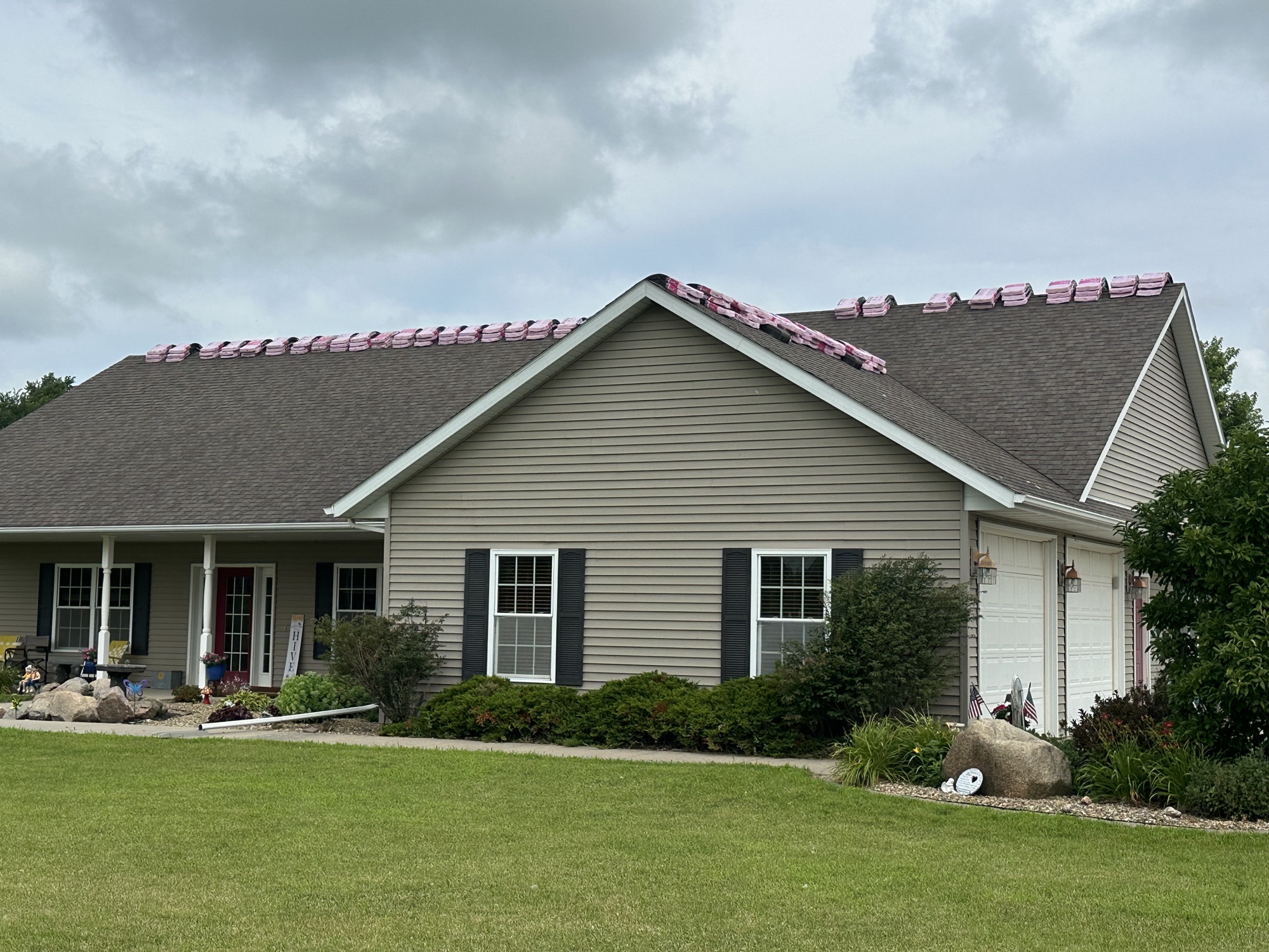 Ranch home with a shingle roof replacement underway