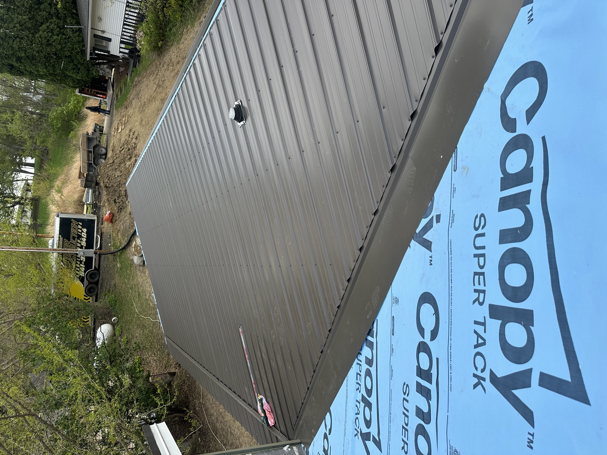 New brown metal roof panels viewed from the ridge