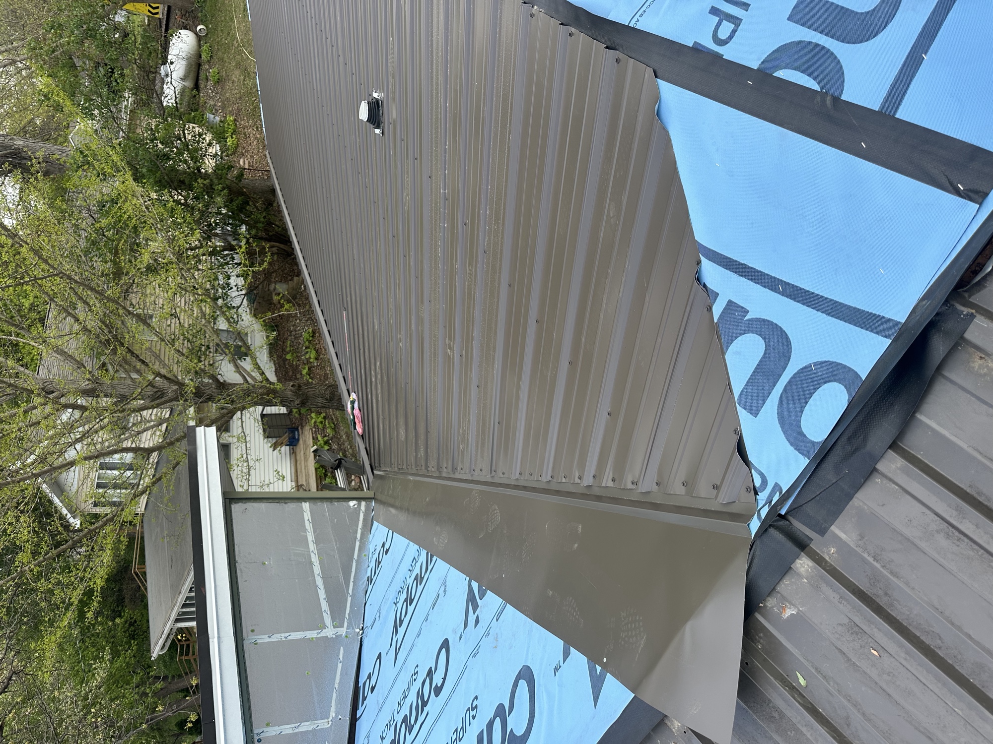 Valley detail on a brown metal roof installation