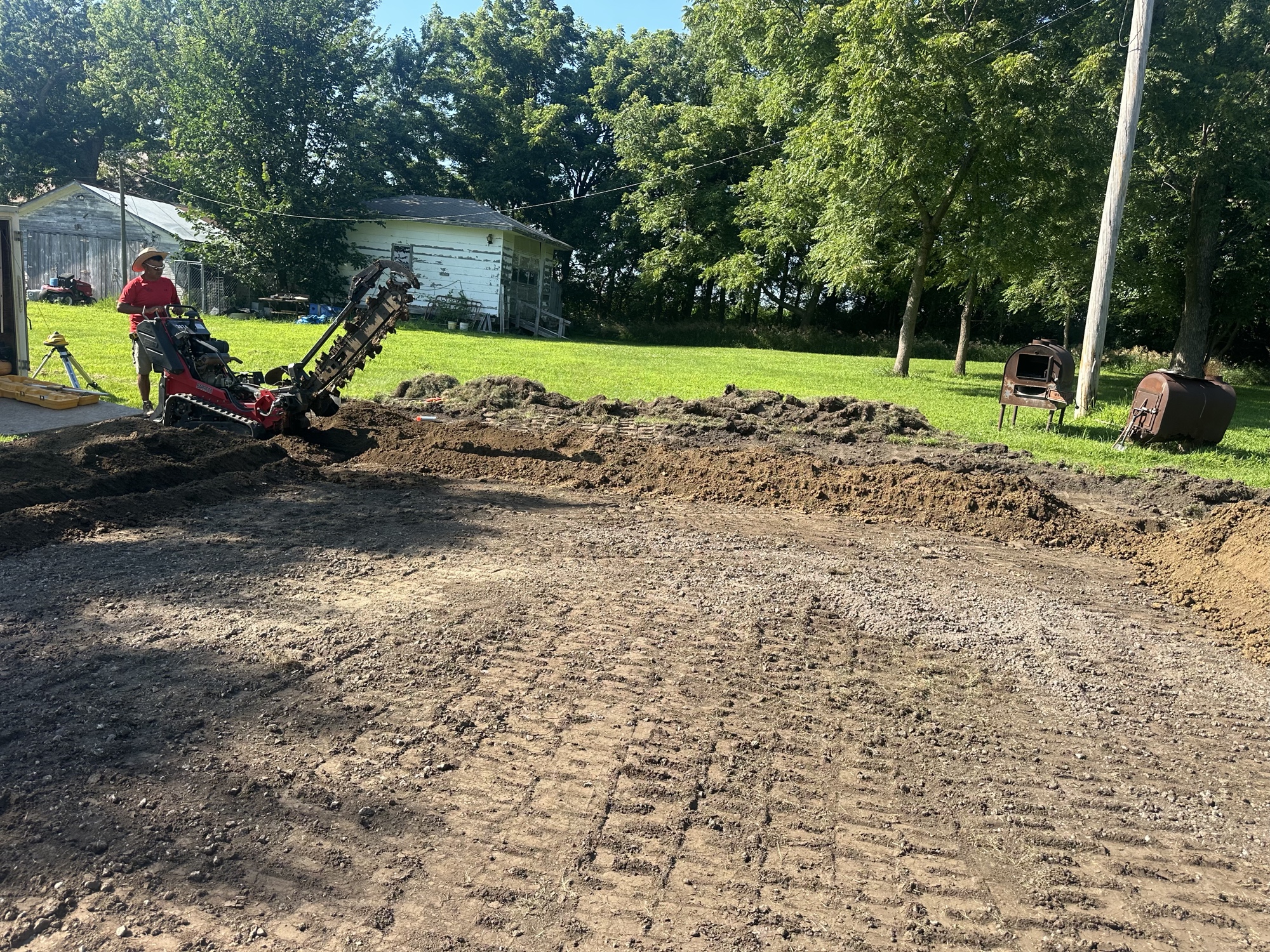 Trencher and graded dirt during site preparation