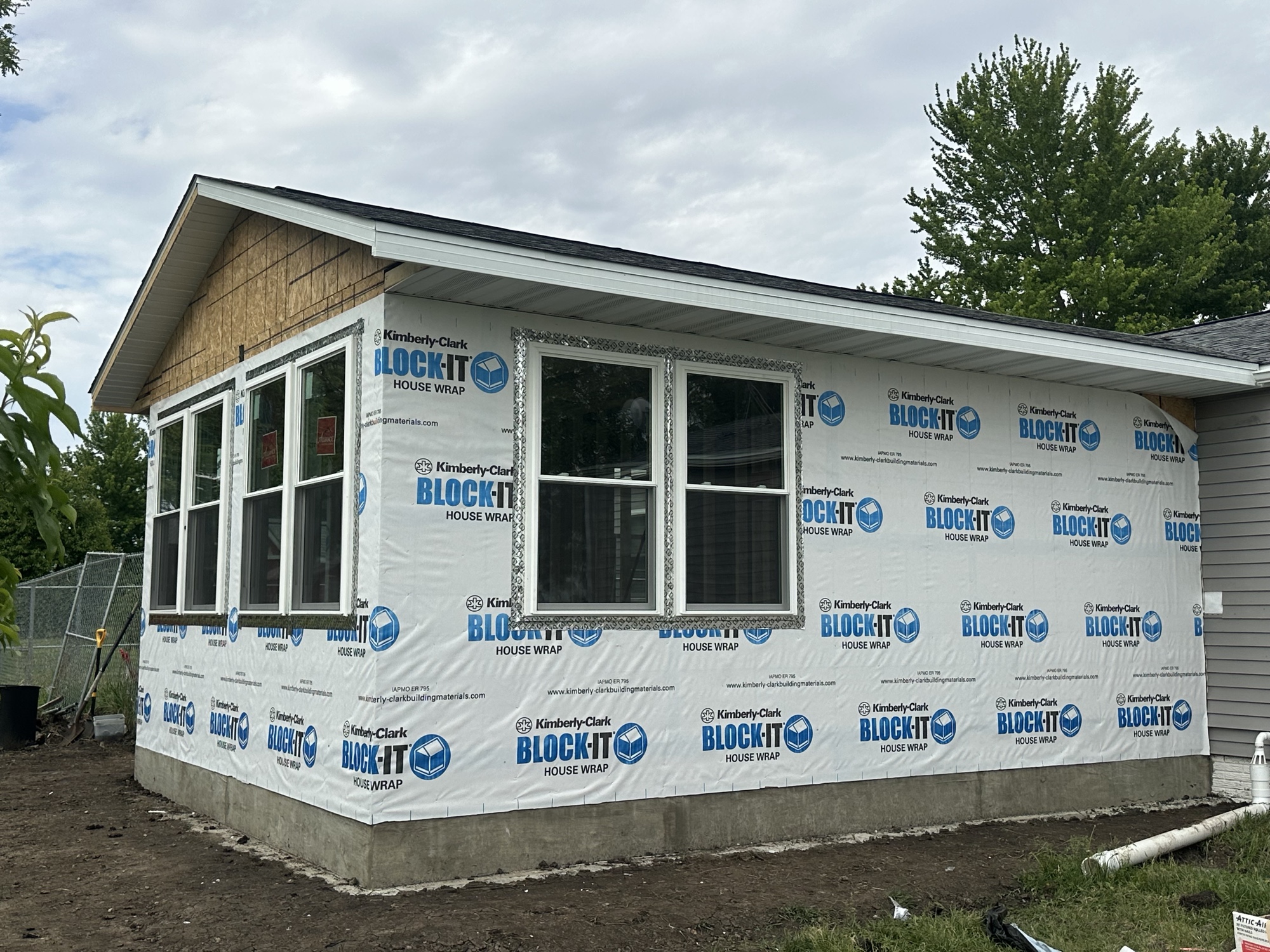 Sunroom addition wrapped and windows installed